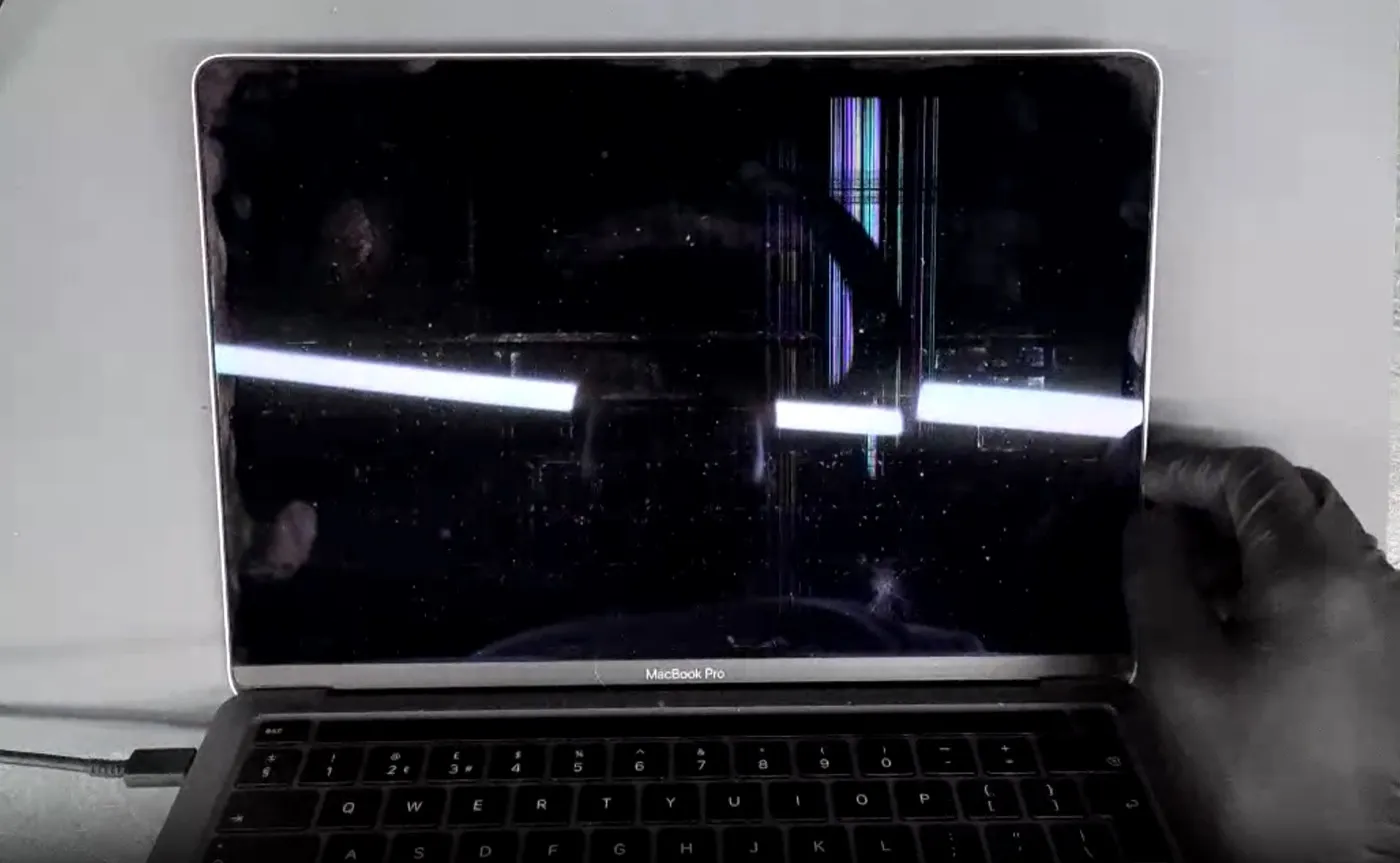 MacBook screen damage example — Dead panel with backlight banding and internal lines