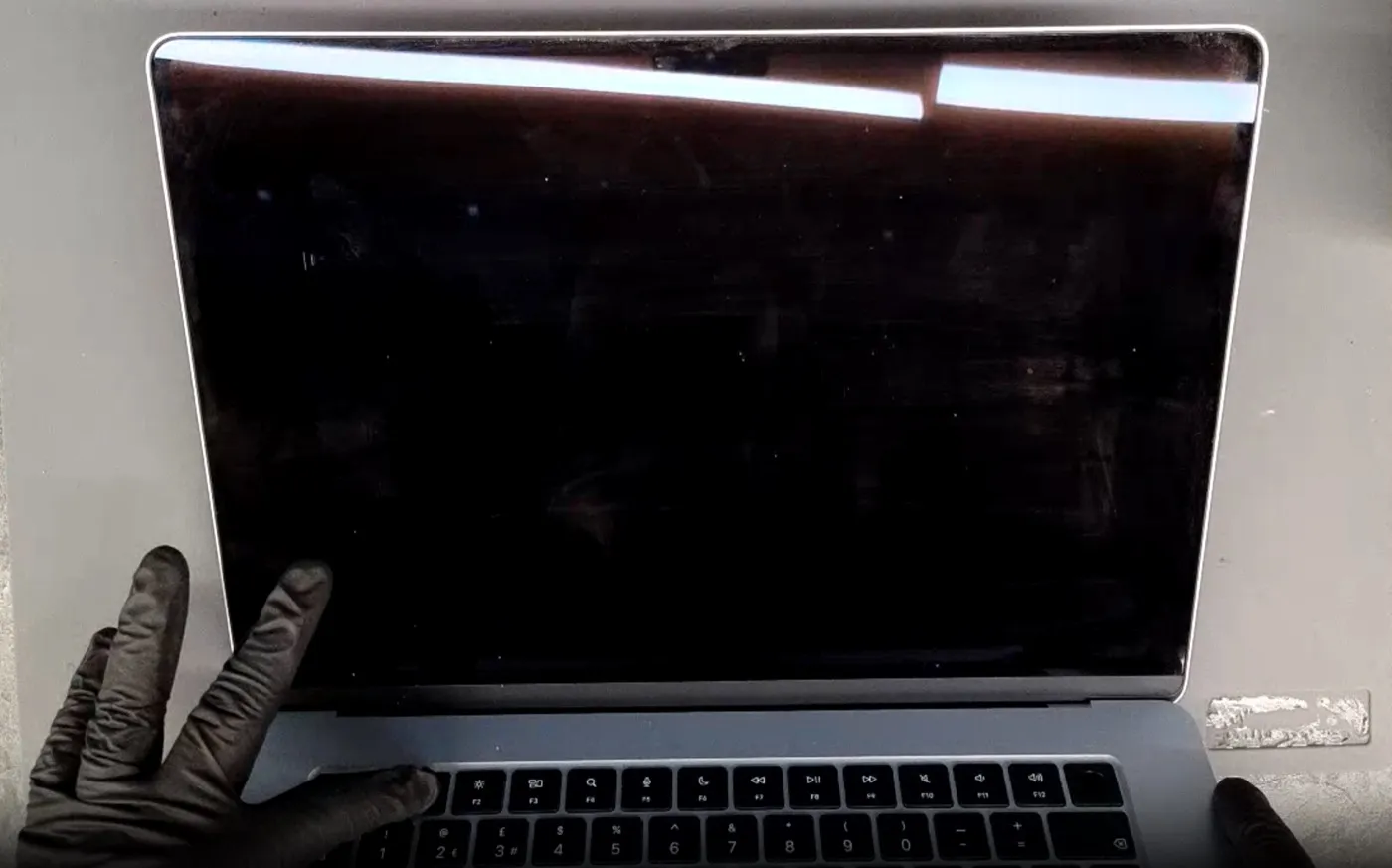 MacBook screen damage example — Completely black display — no image at all
